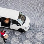 aerial-view-of-delivery-man-courier-with-face-mask-2024-10-21-08-45-34-utc_11zon